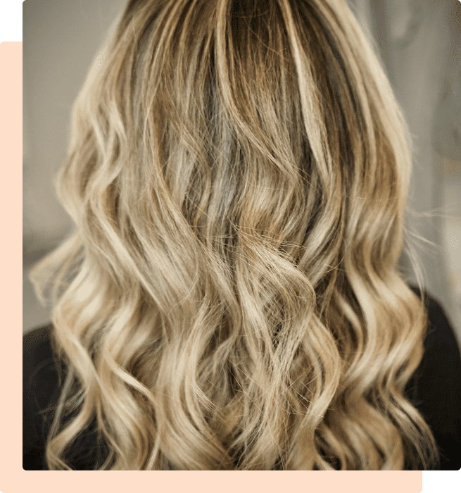 Long, wavy blonde hair cascading down the back.