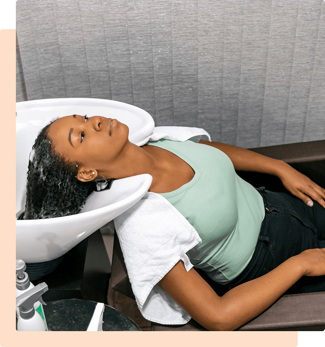 Woman relaxing while getting her hair washed at a salon.